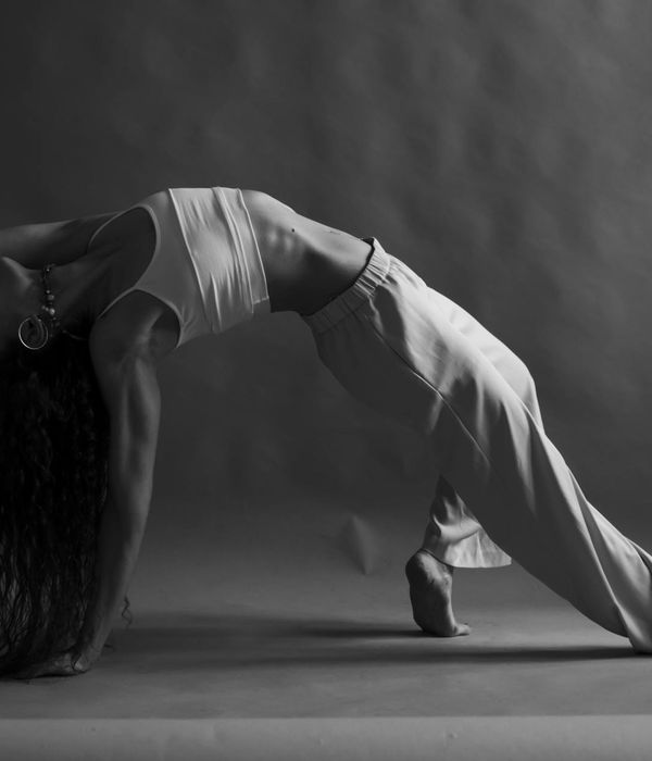 Woman in a graceful yoga pose, symbolizing strength and inner peace.